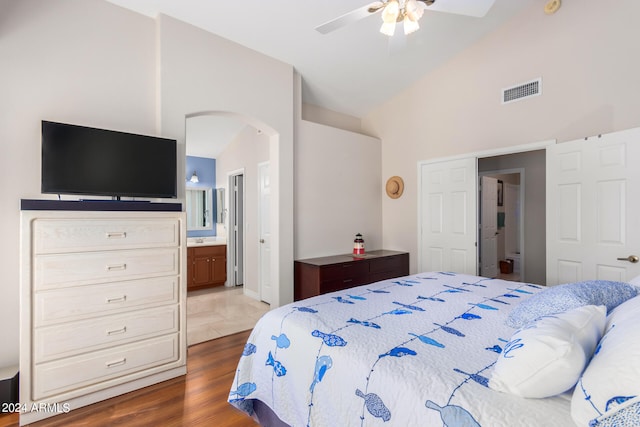 bedroom featuring connected bathroom, ceiling fan, high vaulted ceiling, and dark hardwood / wood-style floors