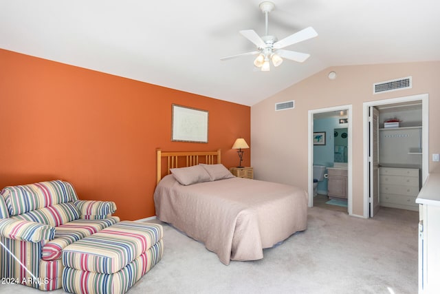 carpeted bedroom featuring ensuite bath, vaulted ceiling, and ceiling fan