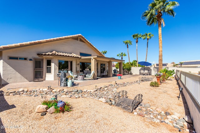 rear view of property featuring a patio area