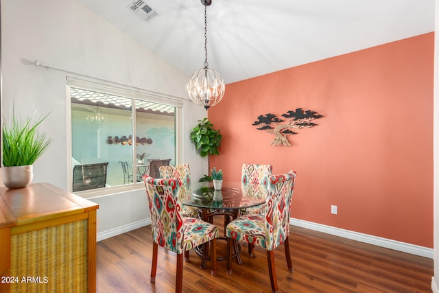 dining area featuring a notable chandelier, wood-type flooring, and vaulted ceiling