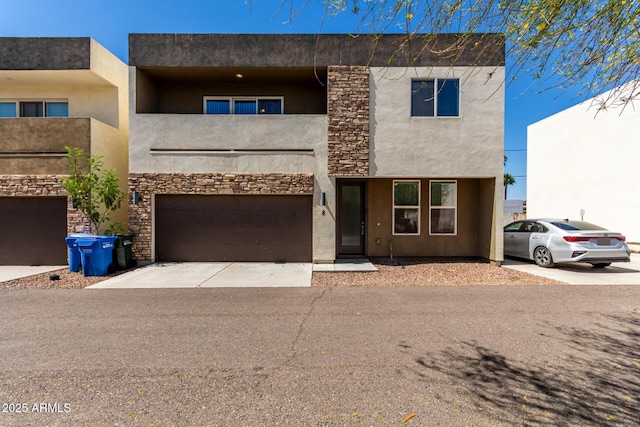 2000 N 36th St Unit 8, Phoenix, AZ 85008 - view of front of house with a garage, driveway, stucco siding, and stone siding
