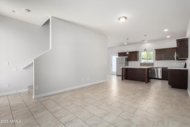 2000 N 36th St Unit 8, Phoenix, AZ 85008 - kitchen with stainless steel appliances, dark brown cabinetry, light countertops, recessed lighting, and hanging light fixtures