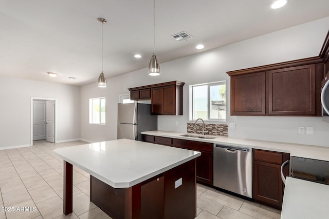 2000 N 36th St Unit 8, Phoenix, AZ 85008 - kitchen featuring stainless steel dishwasher, freestanding refrigerator, light countertops, light tile patterned floors, and decorative light fixtures