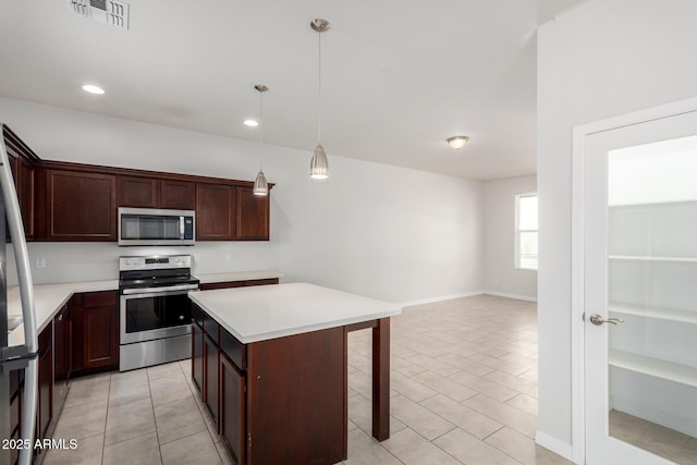 2000 N 36th St Unit 8, Phoenix, AZ 85008 - kitchen featuring appliances with stainless steel finishes, light countertops, a breakfast bar area, a kitchen island, and recessed lighting