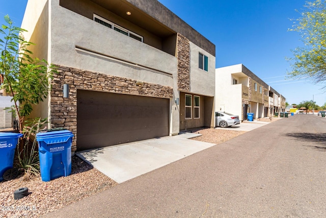 2000 N 36th St Unit 8, Phoenix, AZ 85008 - view of property with an attached garage, driveway, and a residential view