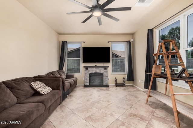 3016 W White Canyon Rd, San Tan Valley, AZ 85144 - living area featuring healthy amount of natural light, a ceiling fan, a stone fireplace, and light tile patterned flooring