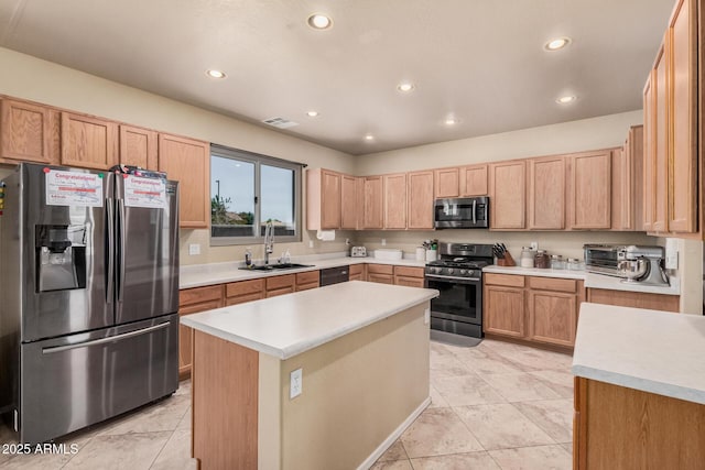 3016 W White Canyon Rd, San Tan Valley, AZ 85144 - kitchen featuring appliances with stainless steel finishes, light countertops, recessed lighting, light brown cabinets, and a center island