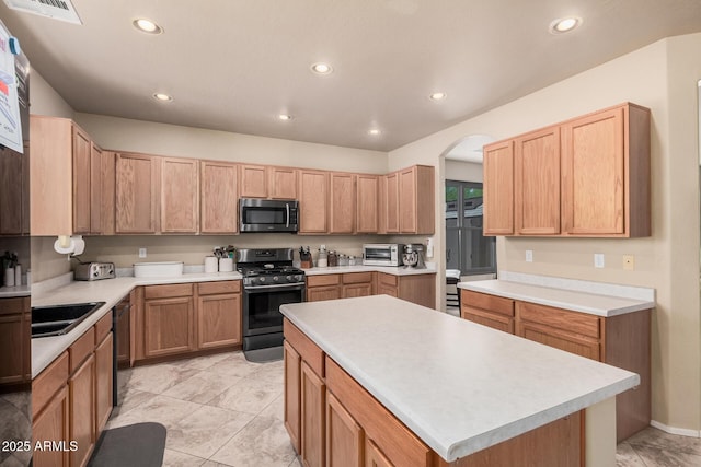 3016 W White Canyon Rd, San Tan Valley, AZ 85144 - kitchen with stainless steel appliances, recessed lighting, light countertops, a kitchen island, and arched walkways