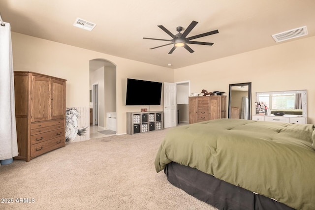 3016 W White Canyon Rd, San Tan Valley, AZ 85144 - bedroom featuring arched walkways, carpet floors, ceiling fan, and connected bathroom