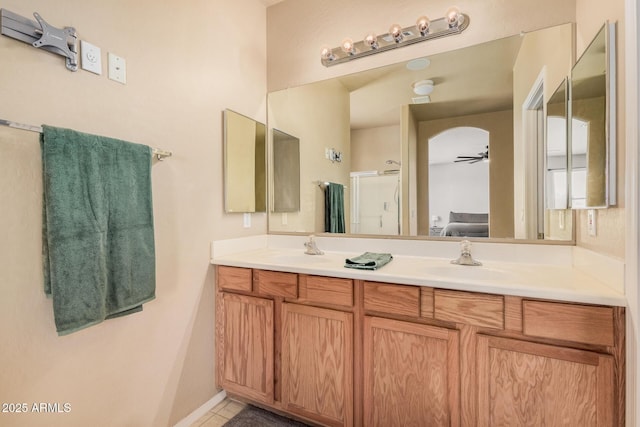 3016 W White Canyon Rd, San Tan Valley, AZ 85144 - bathroom featuring double vanity, tile patterned flooring, a shower with shower door, and ceiling fan