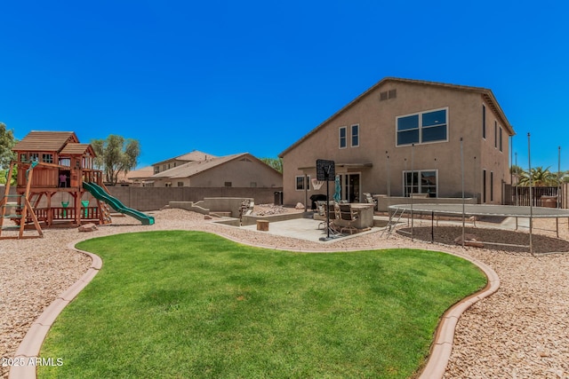 3016 W White Canyon Rd, San Tan Valley, AZ 85144 - back of property featuring a playground, a trampoline, stucco siding, and a patio area