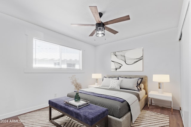 bedroom with ceiling fan and hardwood / wood-style flooring