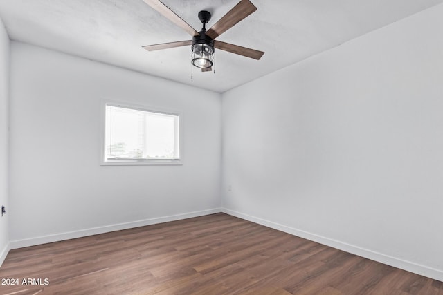 empty room with dark hardwood / wood-style flooring