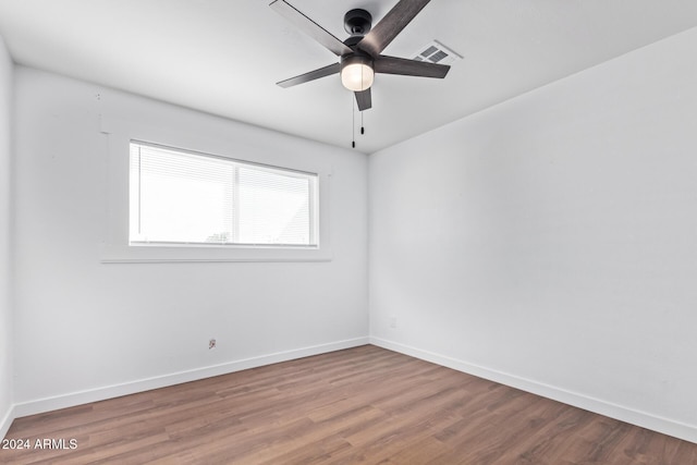 spare room with hardwood / wood-style floors and ceiling fan