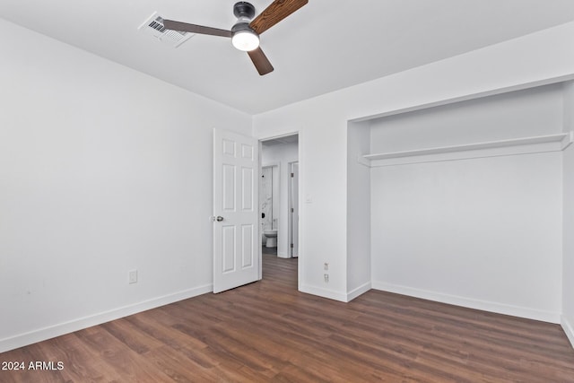 unfurnished bedroom with dark hardwood / wood-style flooring, a closet, and ceiling fan