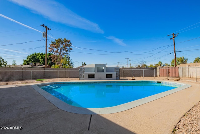 view of swimming pool with a patio area