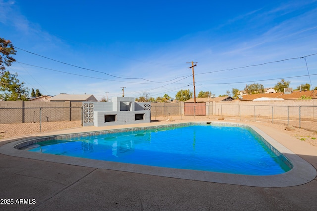 view of pool featuring an outdoor fireplace