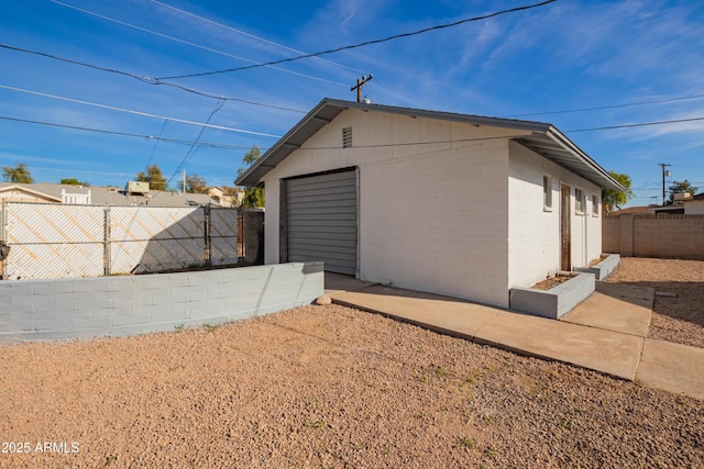 exterior space with a garage and an outdoor structure