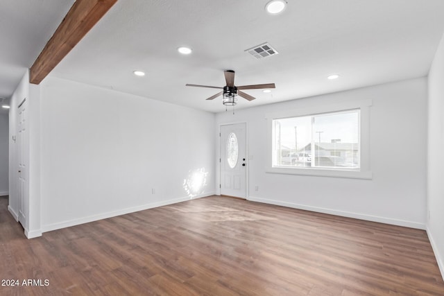 interior space featuring ceiling fan, beam ceiling, and dark wood-type flooring