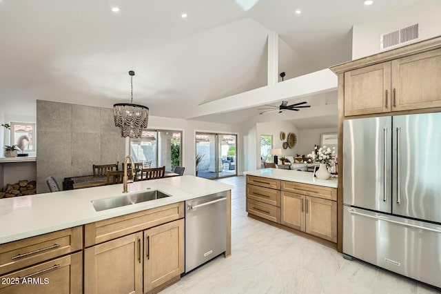 10023 E Sunnyslope Ln, Scottsdale, AZ 85258 - kitchen with appliances with stainless steel finishes, a sink, light countertops, open floor plan, and a chandelier