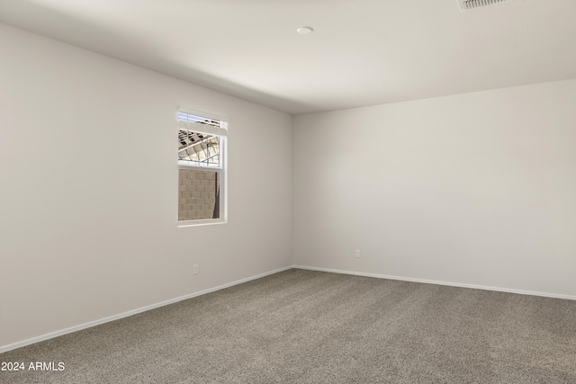 carpeted empty room with baseboards