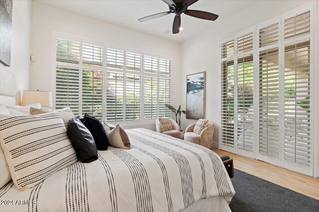 bedroom with light wood-type flooring, ceiling fan, and access to exterior