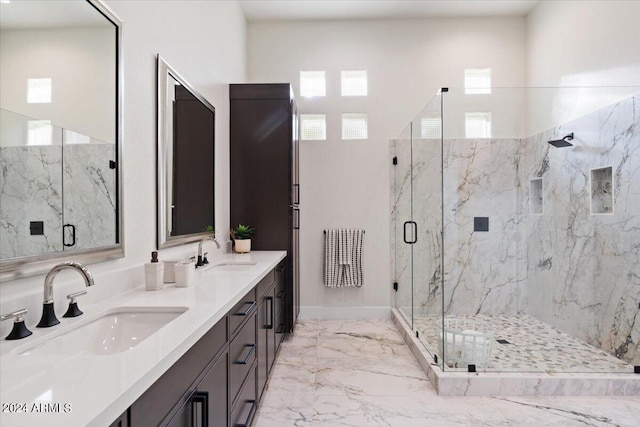 full bath with marble finish floor, a sink, a marble finish shower, and double vanity