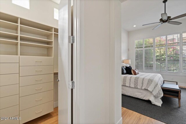 bedroom with ceiling fan and light hardwood / wood-style floors