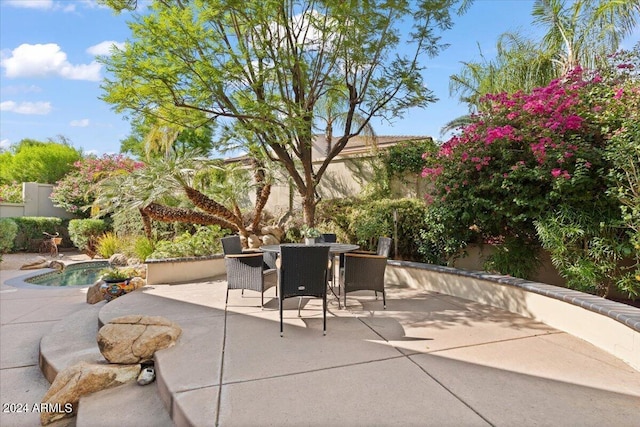 view of patio featuring fence and outdoor dining area