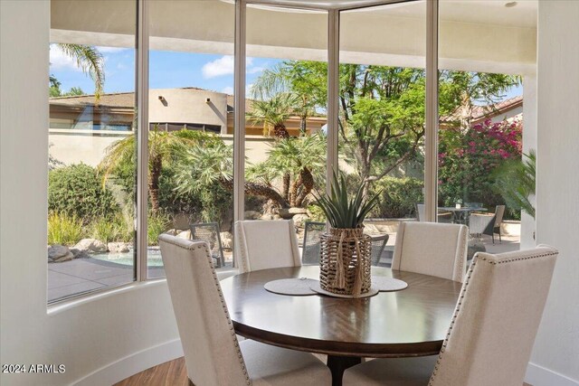 dining area featuring wood-type flooring and plenty of natural light