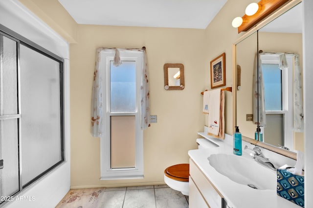 full bathroom featuring marble finish floor, a shower with shower door, and vanity