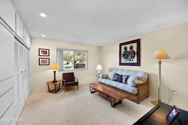 living area with a textured ceiling, carpet floors, recessed lighting, and baseboards