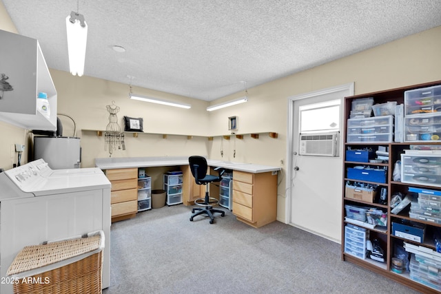 office space featuring water heater, separate washer and dryer, a textured ceiling, and light colored carpet