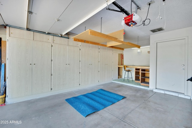 garage featuring visible vents and a garage door opener