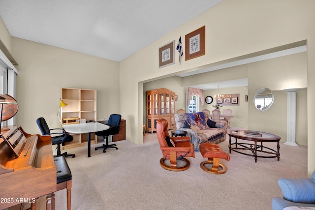 carpeted office space with a notable chandelier