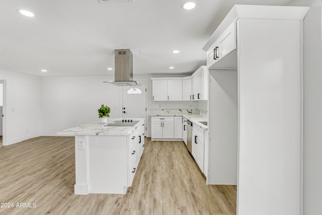 kitchen with black electric cooktop, light hardwood / wood-style floors, extractor fan, a center island, and white cabinets