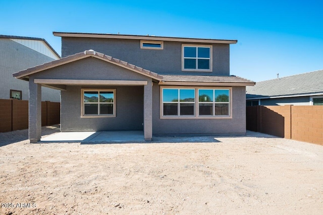 back of property featuring a patio, a fenced backyard, a tiled roof, and stucco siding