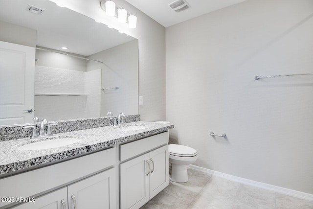 bathroom with toilet, visible vents, and a sink