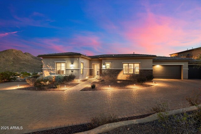 6535 W Gold Mountain Pass, Phoenix, AZ 85083 - prairie-style home with an attached garage, decorative driveway, stucco siding, and stone siding
