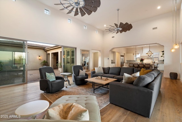 6535 W Gold Mountain Pass, Phoenix, AZ 85083 - living area with light wood-style floors, ceiling fan, recessed lighting, and a towering ceiling