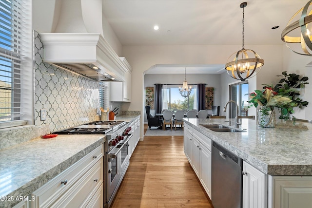 6535 W Gold Mountain Pass, Phoenix, AZ 85083 - kitchen featuring tasteful backsplash, custom range hood, a sink, appliances with stainless steel finishes, and a notable chandelier