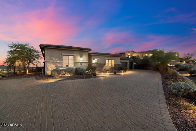6535 W Gold Mountain Pass, Phoenix, AZ 85083 - view of front of house featuring decorative driveway, an attached garage, fence, and stucco siding