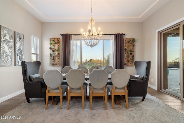 6535 W Gold Mountain Pass, Phoenix, AZ 85083 - dining area with baseboards, plenty of natural light, wood finished floors, and a notable chandelier