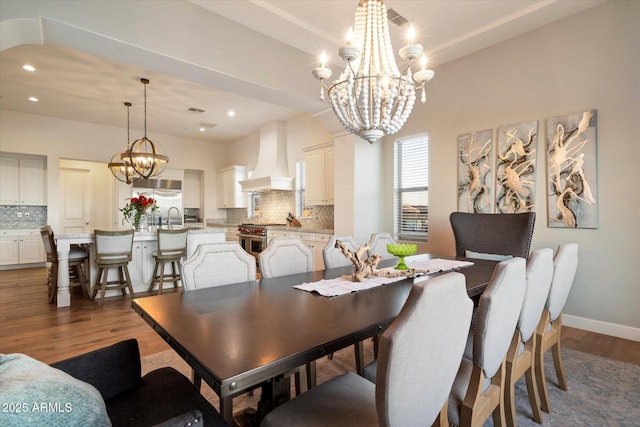 6535 W Gold Mountain Pass, Phoenix, AZ 85083 - dining space featuring an inviting chandelier, recessed lighting, baseboards, wood finished floors, and visible vents