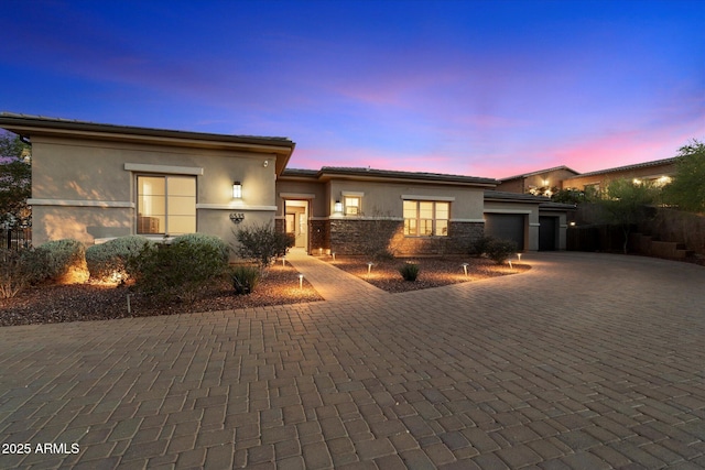 6535 W Gold Mountain Pass, Phoenix, AZ 85083 - prairie-style house with a garage, stucco siding, decorative driveway, and stone siding