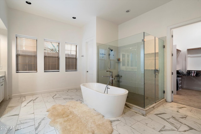 6535 W Gold Mountain Pass, Phoenix, AZ 85083 - full bathroom with vanity, marble finish floor, a walk in closet, a freestanding bath, and a stall shower