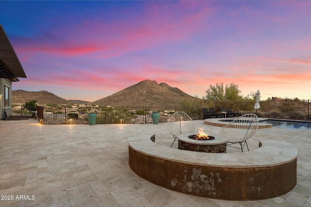 6535 W Gold Mountain Pass, Phoenix, AZ 85083 - view of patio / terrace with a fenced in pool, an outdoor fire pit, a mountain view, and fence