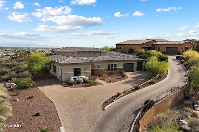 6535 W Gold Mountain Pass, Phoenix, AZ 85083 - prairie-style home with fence, decorative driveway, stucco siding, an attached garage, and a mountain view