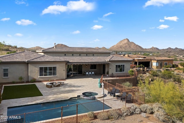 6535 W Gold Mountain Pass, Phoenix, AZ 85083 - back of property with a fenced backyard, a mountain view, stucco siding, and a fire pit
