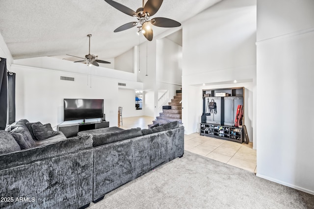 7949 W Pershing Ave, Peoria, AZ 85381 - tiled living area with a ceiling fan, stairs, carpet flooring, high vaulted ceiling, and a textured ceiling